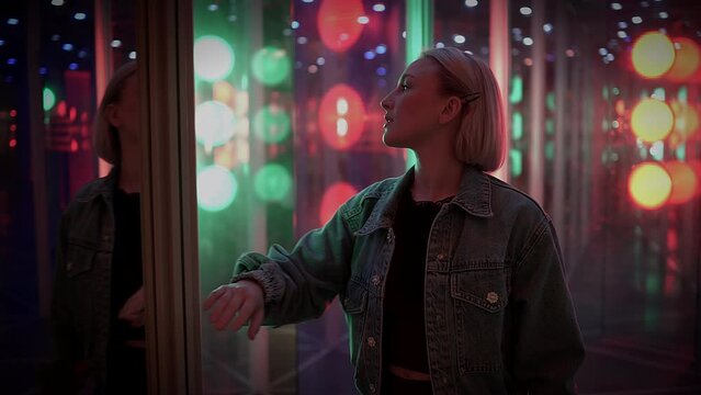 Young Blond Woman Exploring Room of Mirrors in Dreamlike Fantasy Neon Light