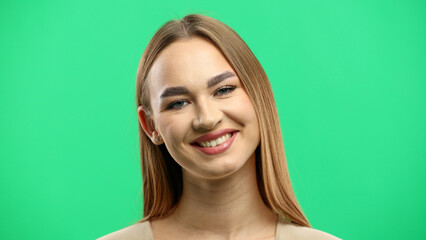 Woman's face, close-up, on a green background