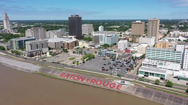 Baton Rouge, Louisiana, USA - April 21, 2024: Afternoon sun shines on the Mississippi River and historic skyscrapers of the downtown Baton Rouge skyline.