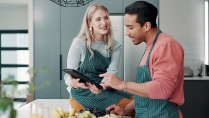 Tablet, video and cooking in kitchen with couple reading healthy ebook, app and online learning. Happy, man and woman relax with tech in home and watch meal prep info with fruit and vegetables