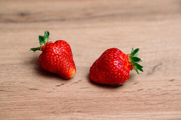 Fresh delicious selected strawberries on a brown wooden table
