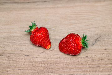 Fresh delicious selected strawberries on a brown wooden table