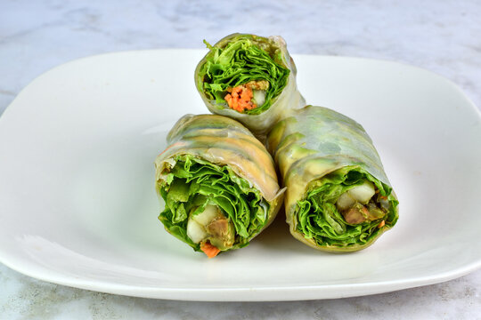 three spring rolls  with lettuce cucmber and carrots