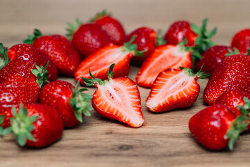 Fresh delicious selected strawberries on a brown wooden table
