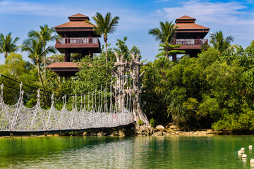 Rope suspension bridge and lush vegetation at Palawan Beach, Singapore