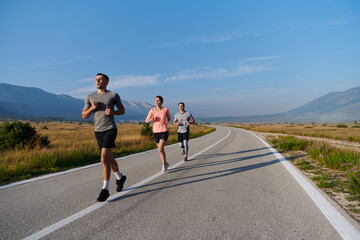 A group of friends maintains a healthy lifestyle by running outdoors on a sunny day, bonding over fitness and enjoying the energizing effects of exercise and nature