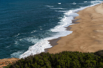 View from the hill to the sandy beach 'Praia da Nazaré' , Praia do Norte beach and Nazare town, Portugal