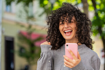 Caucasian young woman use mobile smartphone celebrating win good message news, lottery casino...