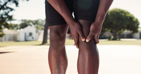 Sports, knee pain and athlete with injury outdoor at basketball court for exercise, fitness or training accident. Hands, legs and person massage muscle for arthritis, fibromyalgia or health problem