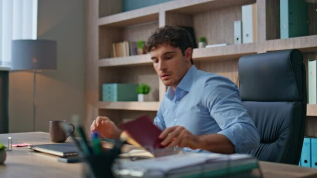 Manager start working day with coffee cup. Young man executive opening laptop