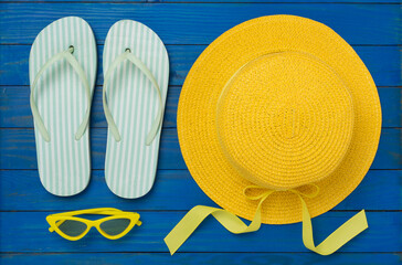 Flat lay with colorful beach accessories on wooden background. Vacation concept