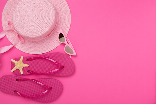 Flat lay with pink summer outfit on color background. Vacation concept
