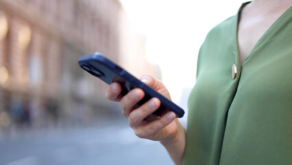 Young woman using smartphone in the city	
