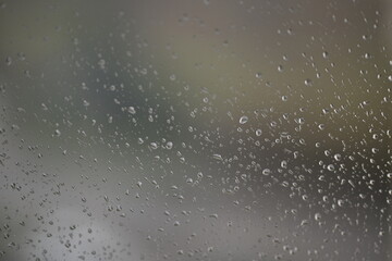Water drops on fogged glass with a gray brightness gradient