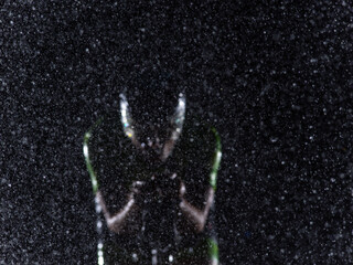 A triathlete braving the rain as he cycles through the night, preparing himself for the upcoming...