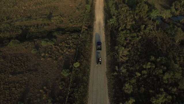 Aerial Forward Tilt Up Shot Of Pick-Up Truck Pulling Boat On Road In Field During Sunny Day - Bayou Vista, Texas