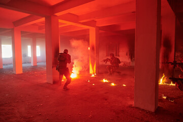  A group of professional soldiers bravely executes a dangerous rescue mission, surrounded by fire in a perilous building.