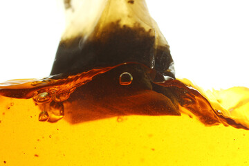 Close up shot of steeping tea bag in hot water