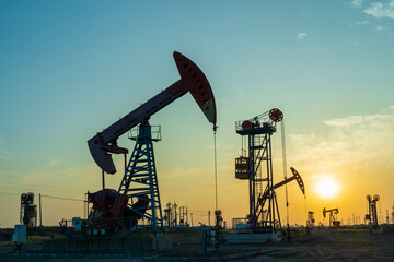 In the evening, oil pumps are running, Silhouette of beam pumping unit