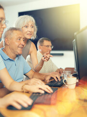 Group of elderly people learn to use computer at master class