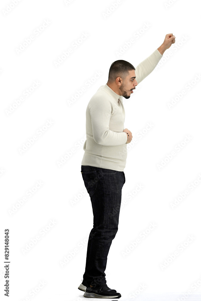 Wall mural A man, full-length, on a white background, raises his hand up