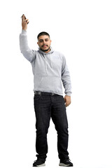 A man, full-length, on a white background, waving his phone