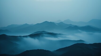 The mountains appearing faded and distant obscured by the thick fog.