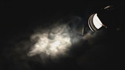 Close-up of spotlight and smoke in dark. Media. Beautiful bright spotlight light with smoke in...