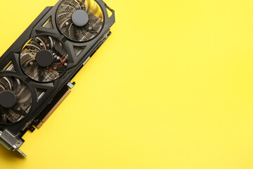 One graphics card on yellow background, top view. Space for text