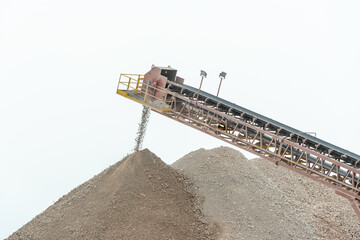 A stockpile of bulk limestone mined in an above ground quarry. The beige pelleted crushed...