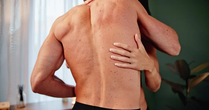 Couple, hands and back with love for affection, intimacy or sexy foreplay in bedroom at home. Rear view of man and woman hug with embrace for romance, sex or sensual touching in care, lust or house