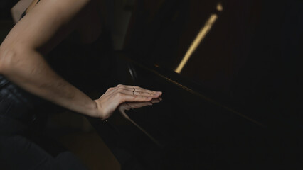 Close-up of woman playing piano. Media. Elegant woman plays piano in accelerated rhythm....