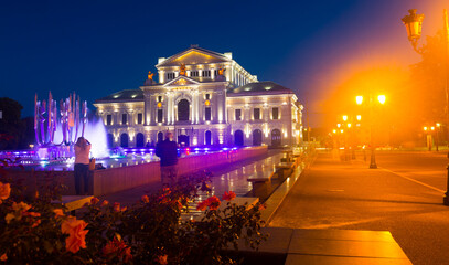 Drobeta Turnu-Severin Cultural Palace with colorful lighted fountain at night