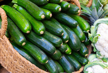 View of zucchini in a wicker basket, put up for sale in a store