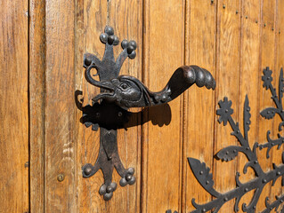 Retro vintage door handle close up. Old wooden door with beautiful retro door knobs in the shape of...