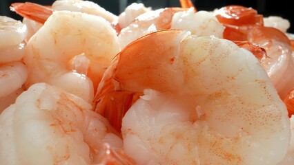 When properly cooked, frozen shrimp have a firm, yet tender texture. They should not be mushy or rubbery. The texture can vary depending on the size and species of shrimp. Seafood background. 
