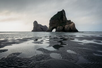 The Archway Islands on Wharaiki Beach at sunset, Puponga, Tasman, New Zealand.