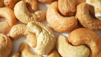 Indulge in the allure of golden-brown roasted cashews, their texture gently wrinkled, promising a...