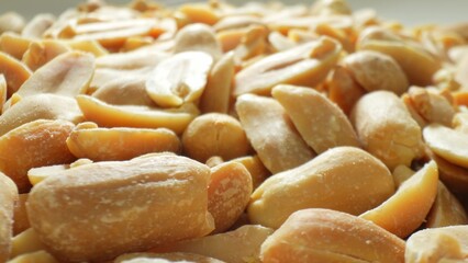 Behold the tantalizing allure of split roasted peanuts, a symphony of light browns and delicate...
