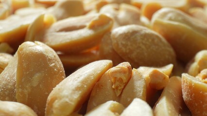 Each roasted peanut, split open to reveal its golden-brown kernel, exudes warmth. The salted...