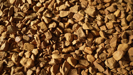 Captured in meticulous detail, the macro image unveils freeze-dried coffee, showcasing its textured landscape. Angular pieces reflect light, narrating the story of preservation through dehydration.
