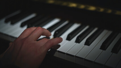 Fototapeta premium Close-up of playing piano. Media. Fingers play gracefully on piano keys. Beautiful piano keyboard playing
