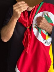 Gaucho with hat, red scarf and flag of the State of Rio Grande do Sul - Southern Brazil.