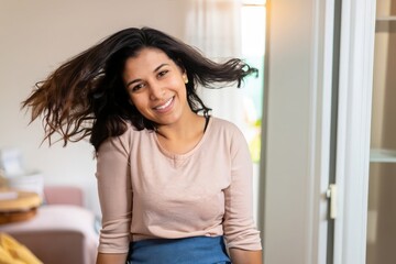 Naklejka premium portrait of a woman, black person, afro american girl, curly hair, young woman in a house, happy housewife