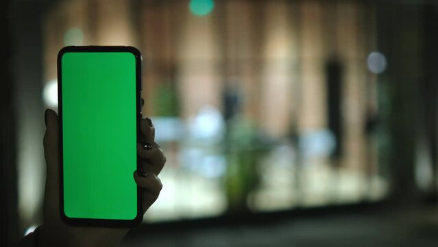 Person using cell phone with green screen for communication and mobile tasks