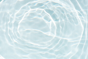 Obraz premium Blue water with ripples on the surface. Defocus blurred transparent blue colored clear calm water surface texture with splashes and bubbles. Water waves with shining pattern texture background.