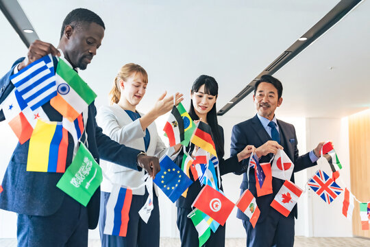 A group of multinational business people holding flags of all nations
