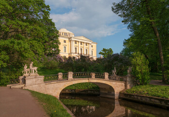 Fototapeta premium Centaur Bridge in Pavlovsky Park against the background of the Pavlovsky Palace on a sunny summer day, garden and park reserve in St. Petersburg, Russia
