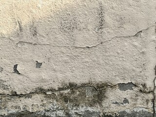 a photography of a wall with a cracky paint and a fire hydrant.