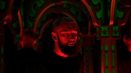 Hipster man dancing and listening to techno music at night club. Media. Interior of neon lighting...